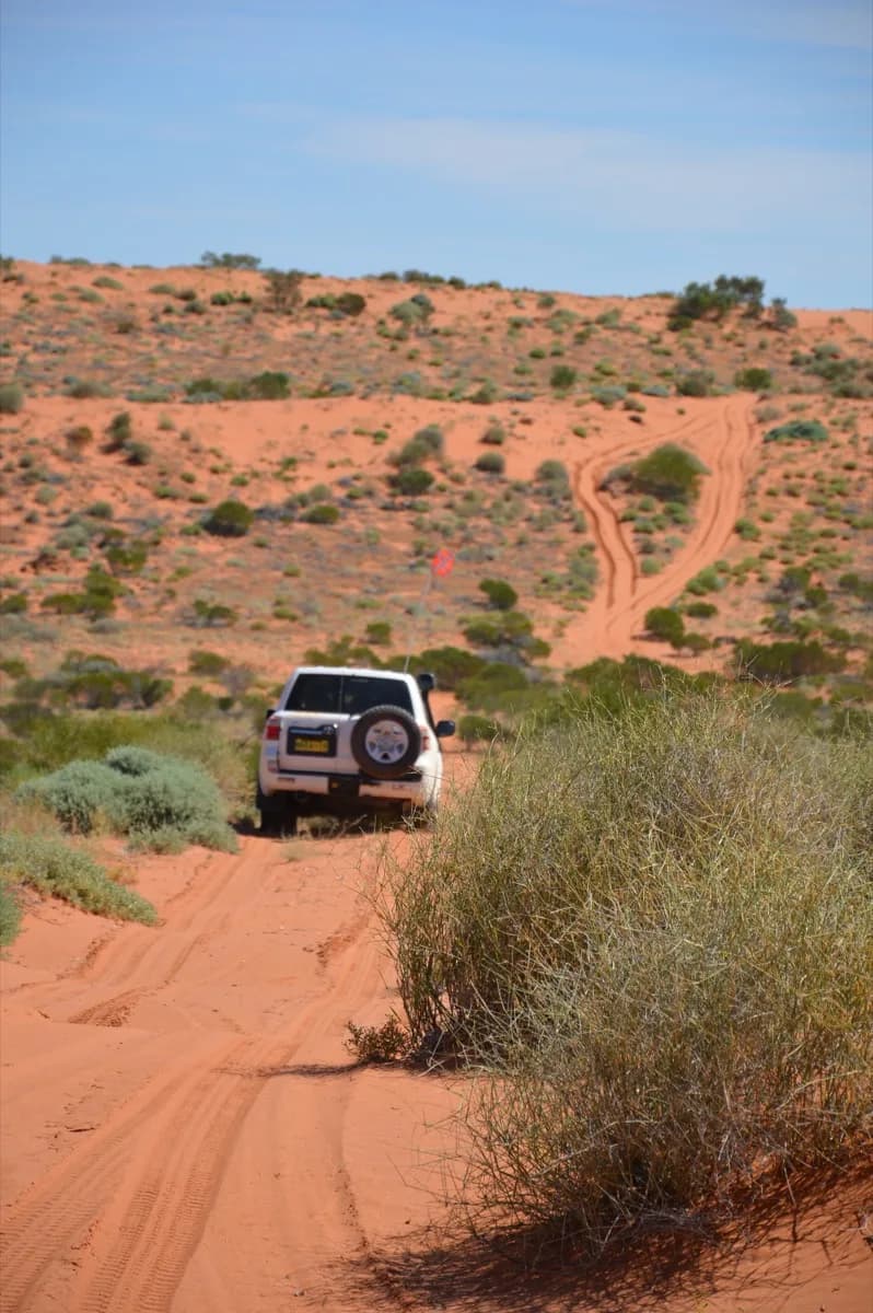 A 4WD on a dirt track in the Simpson Desert